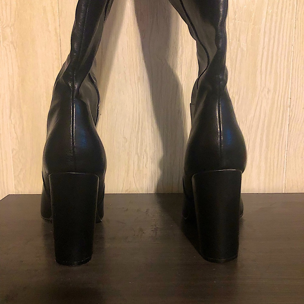 Black faux leather thigh high formal boots. Slightly worn around edges.